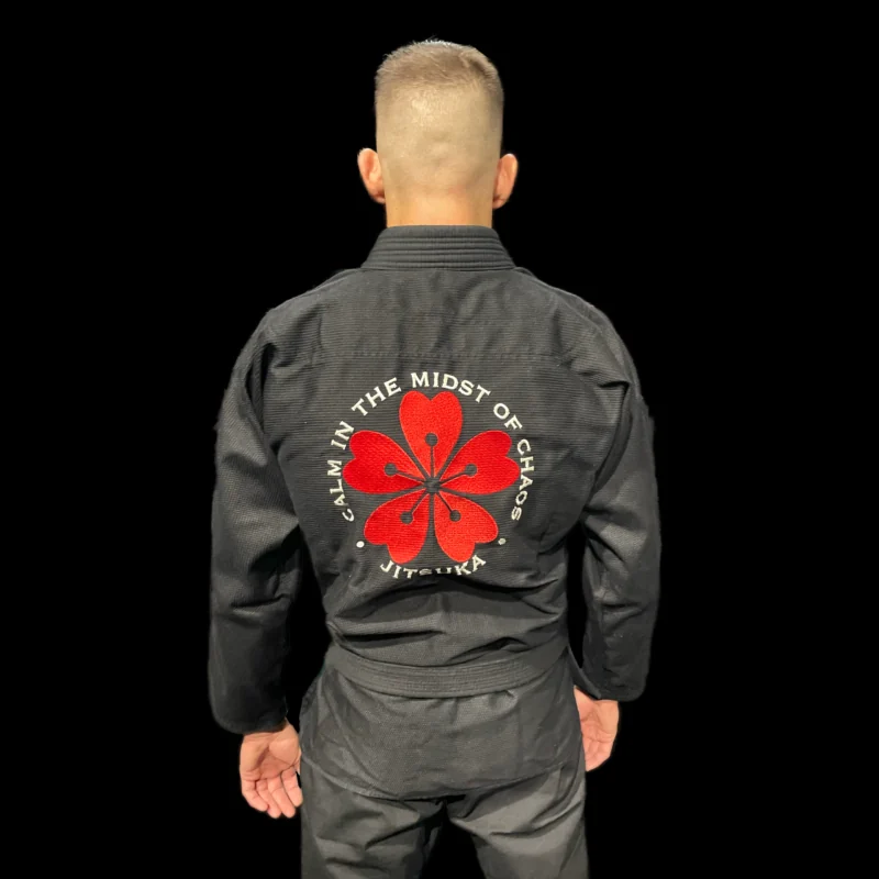 Espalda del kimono Seijaku Warrior con el bordado de la flor y el lema de Jitsuka